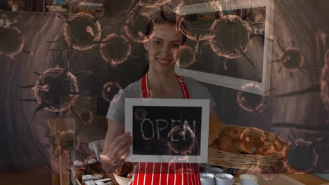 animación de células macro covid-19 flotando sobre una feliz chef caucásica que sostiene un cartel abierto