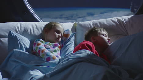 kids sleeping in a space bed