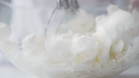 whipping cream in a glass bowl