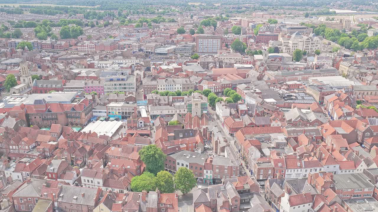 Aerial rising of York city centre, UK, The Shambles market area, historic architecture, shopping district, heritage travel destination in warm sunny weather