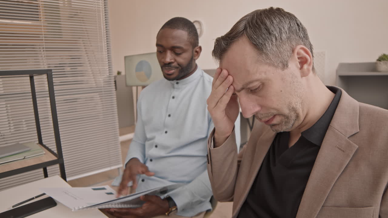 Two Multiethnic Coworkers in Office