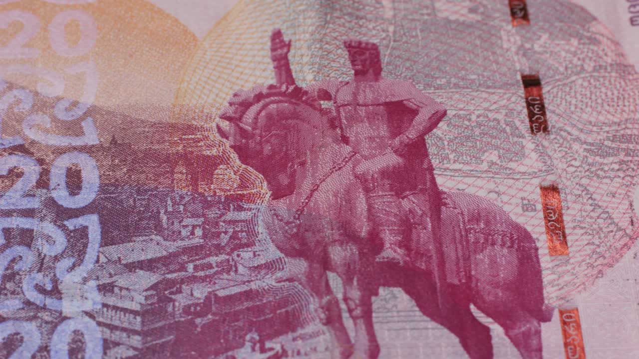 Five Georgian lari banknotes close-up. Universal currency converter GEL Central Bank. 5 lari paper money macro. Economy, financial and banking concept .