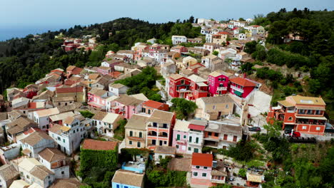 Aerial-drone-shot-over-old-Greek-mountain-village-of-Lakones-in-Corfu-surrounded-in-green-lush-vegetation