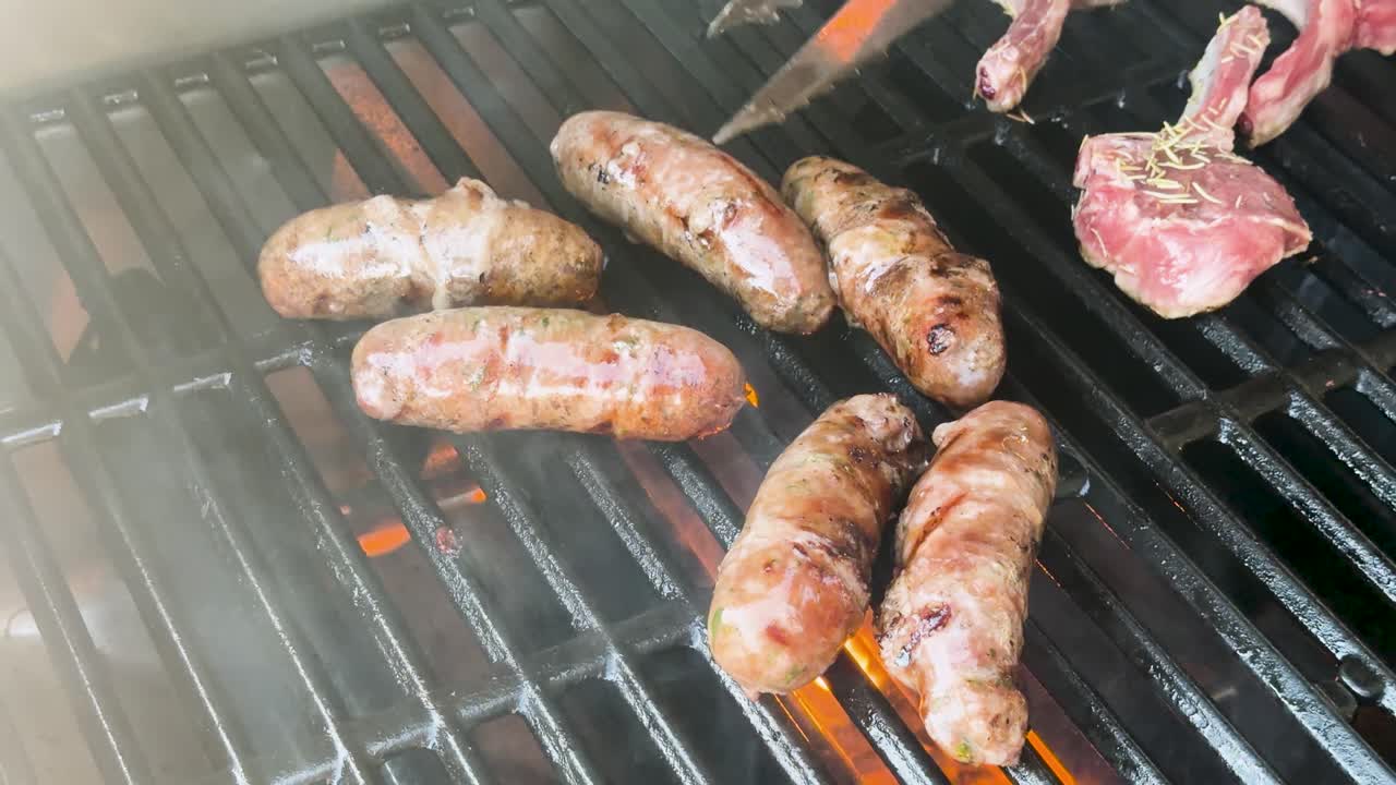 Juicy sausages and lamb cutlets cook over open flames, smoke rising, close-up perspective