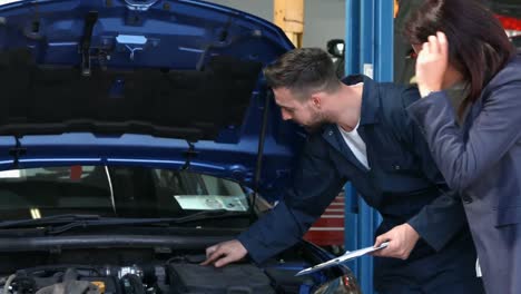 Mechanic-talking-to-a-female-customer