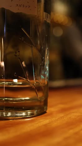 sequence of a hand grabbing a glass off a bar