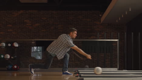 one man throws a bowling ball and knocks out a shoot dances jumps and sings rejoicing in victory