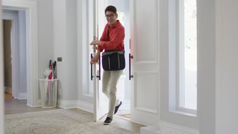 excited asian son at home running to greet his father coming through the front door