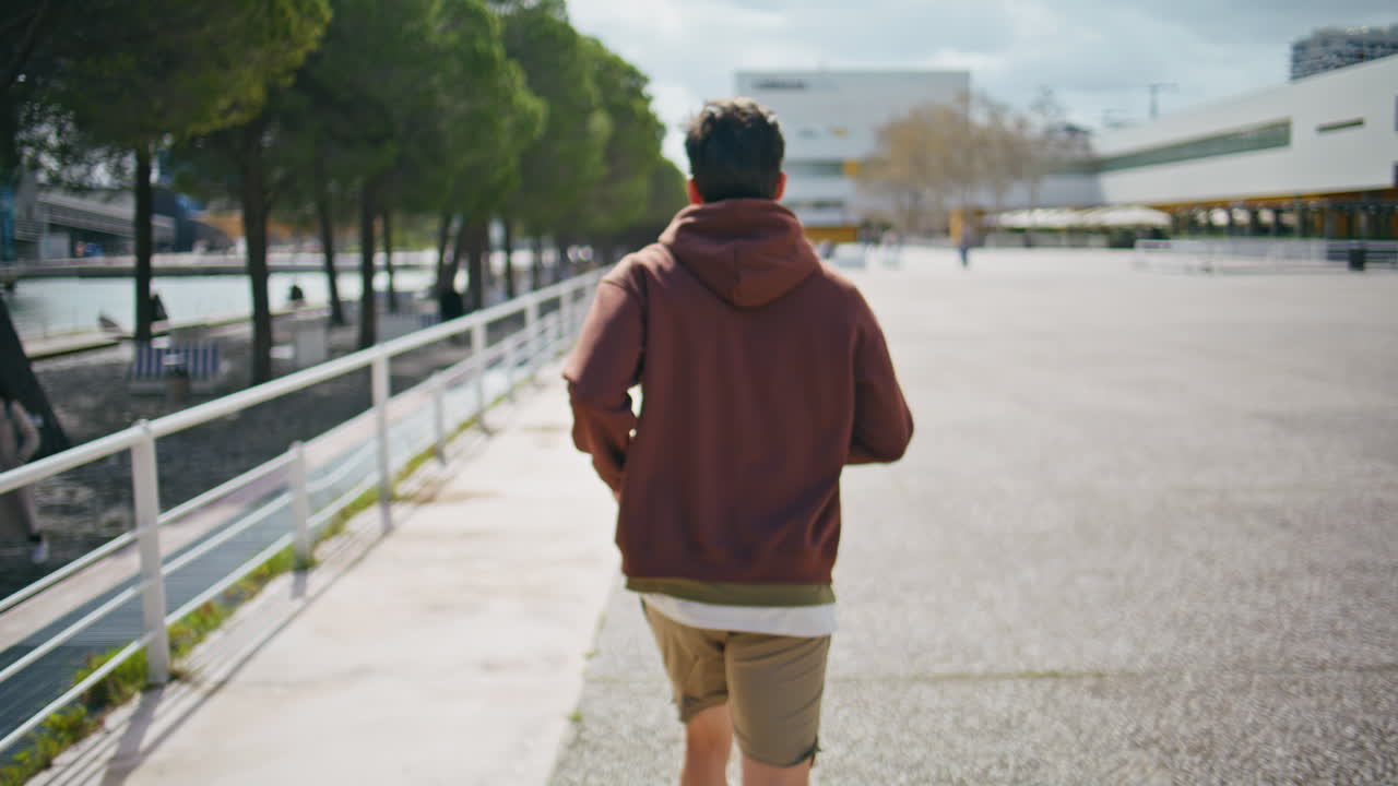 Closeup athletic guy exercising warming up before sprint. Sporty man running