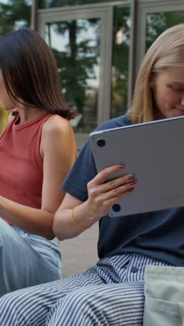 two female friends studying outdoors