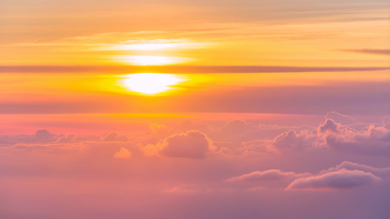 Vibrant Sunset or Sunrise Above a Sea of Pink and Orange Clouds