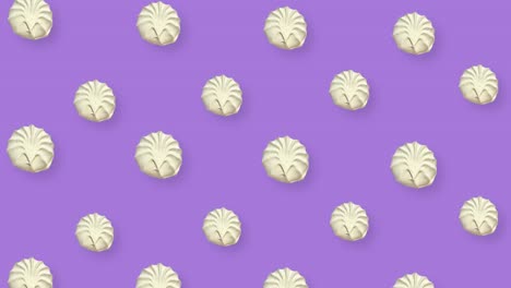 colorful pattern of white zephyr on purple background. seamless pattern with zephyr. marshmallow. top view. realistic animation. 4k video motion