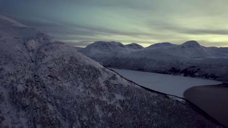 Arctic-mountains-and-a-frozen-fjord-during-the-darkest-time-of-the-year