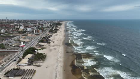 beachfront restaurants at barraca fortal beach in fortaleza city in brazil. aerial drone shot