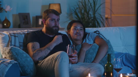 couple watching tv at home
