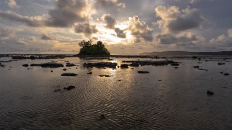 golden hour over a small tropical island at low tide