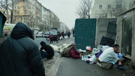 people walking and sitting on a city street