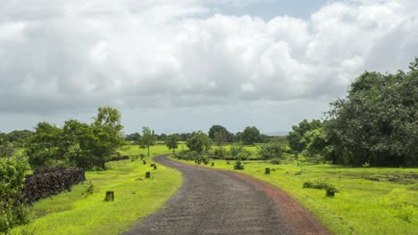 empty road moving clouds shadow green mountain