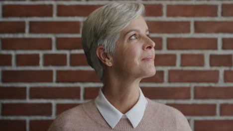 portrait beautiful middle aged woman looking up smiling thinking brainstorming ideas enjoying quiet contemplation senior female day dreaming slow motion