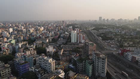 aerial view over dense asian metropolitan cityscape condominiums with highway running past