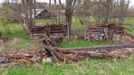 Ruins-of-wooden-homestead-with-stone-foundations,-truck-right-shot