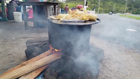 cooking corn on the cob outdoors in a rural setting