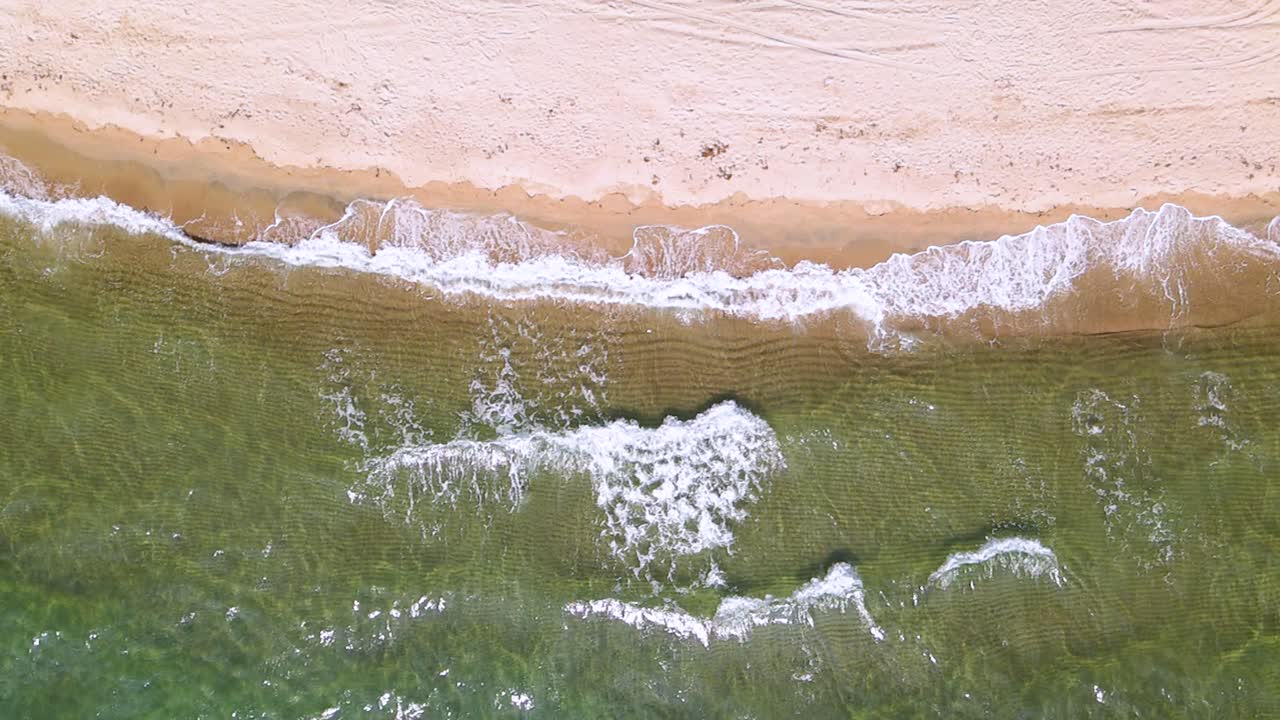 케라모티, 카발라, 북부 그리스의 땅에 으스러지는 수정 같은 물과 파도가 있는 아름다운 해변 위의 슬로우 모션 오버헤드 드론 클립