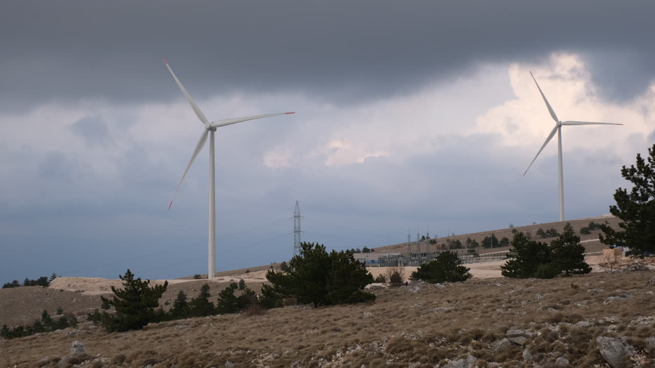 Wind Turbines on a Hilltop Under a Stormy Sky