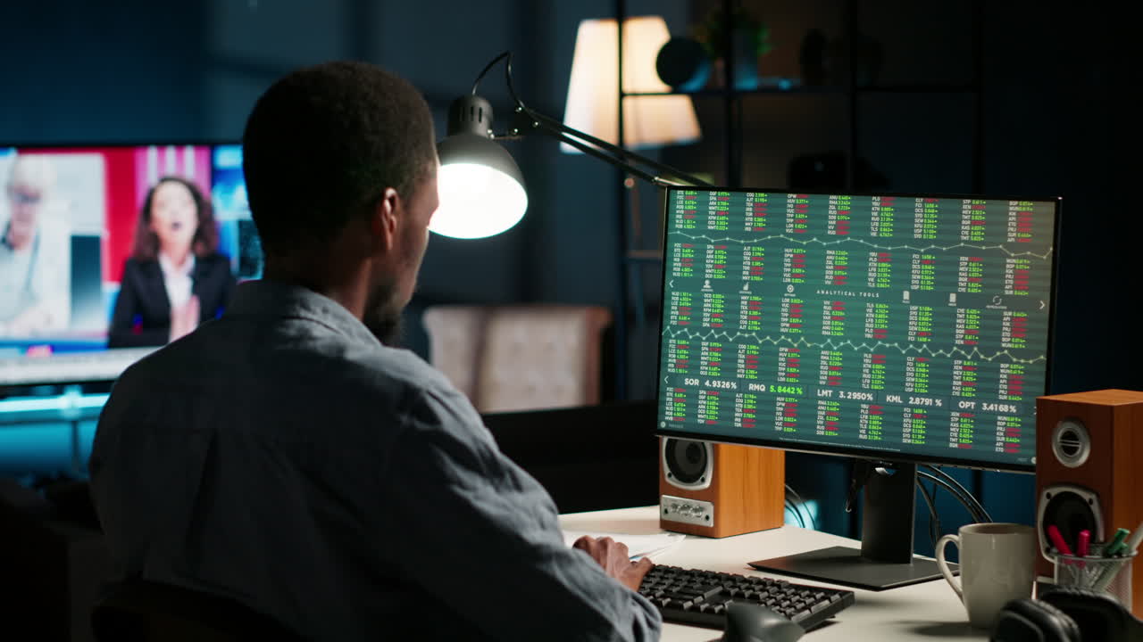Male investor following stock exchange live trends on home computer