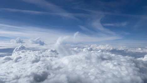 a flight above the white clouds and the sky is blue