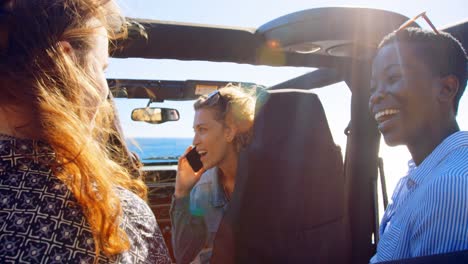 group of female friends interacting each other in the car 4k