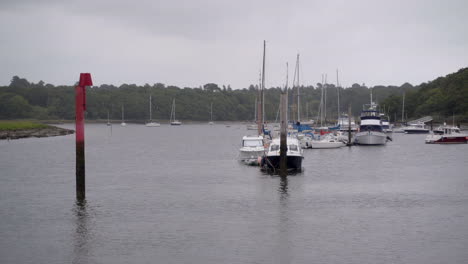 some boats at moorings in the natural harbour at bucklers hard