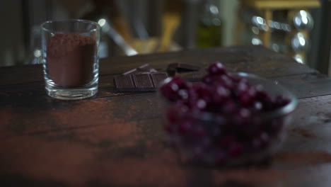 ingredients for baking brownie cake. cherry in glass bowl. cocoa powder in glass