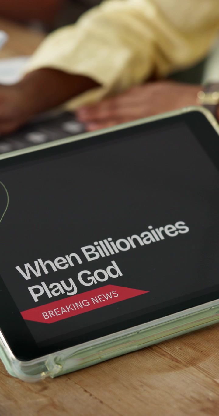 Tablet Displaying Breaking News Headline About Billionaires