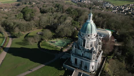 ashton memorial monument in williamson park lancaster uk slow high orbit clockwise from the south showing parkland and monument shadow