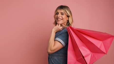 excited shopaholic transgender woman carrying shopping bags