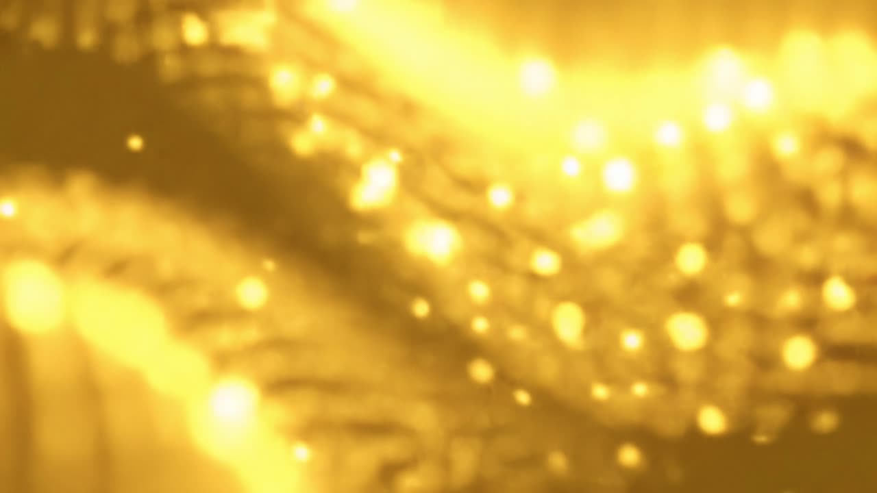 Stunning visual effects create mesmerizing patterns of shimmering gold. Dynamic movement evokes a sense of energy and flow, capturing the beauty of light and texture in a captivating display.