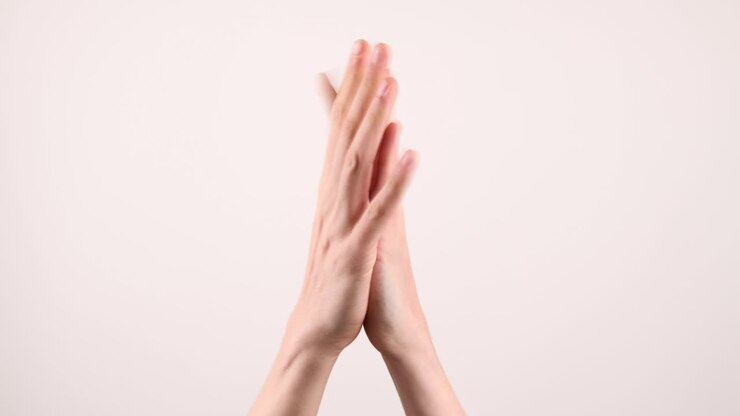 A pair of hands clapping flat in the middle
