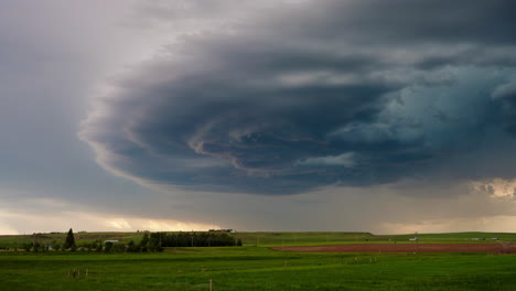 dramatic supercell storm cloud over rural landscape