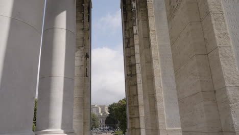 Massive-white-columns-in-downtown-of-Genoa,-camera-tilting-up-view