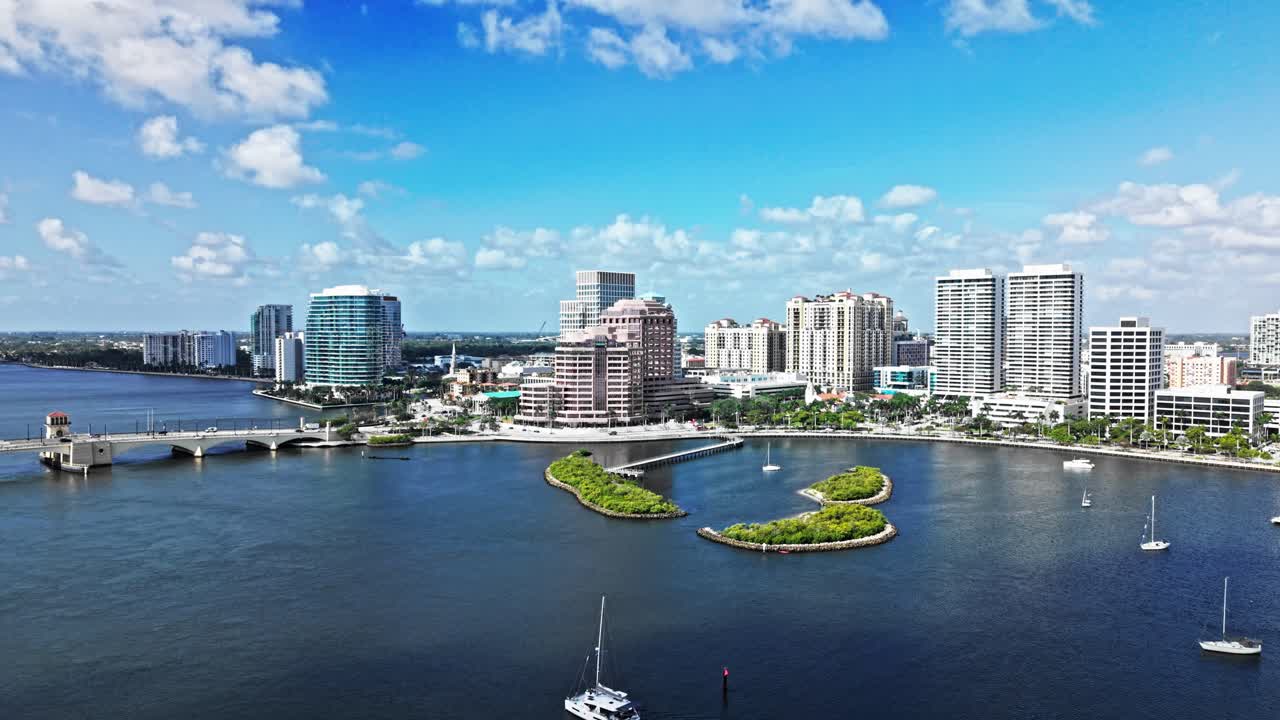 Aerial: One Flagler, Phillips Point Building and West Palm Beach cityscape during the day in Florida, USA, crane up drone shot