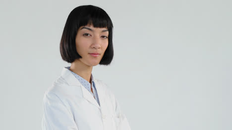 female doctor standing with arms crossed against white background 4k 4k