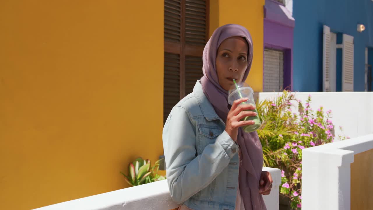 Young woman wearing hijab out and about in the city