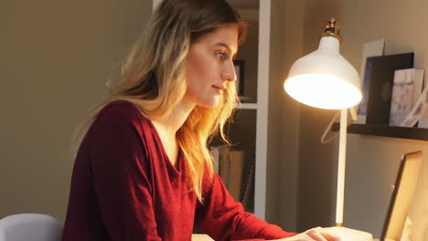 woman sitting at table using laptop 4k