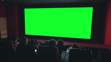 movie theater audience watching a green screen