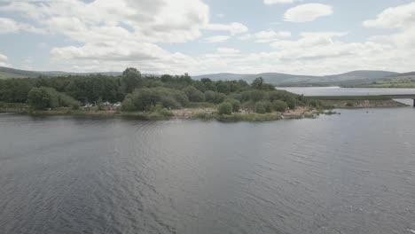 People-Swimming-At-The-Blessington-Lake-In-County-Wicklow,-Ireland-During-Holidays---drone-shot