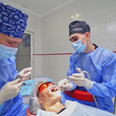 dentist with assistant work in dental clinic