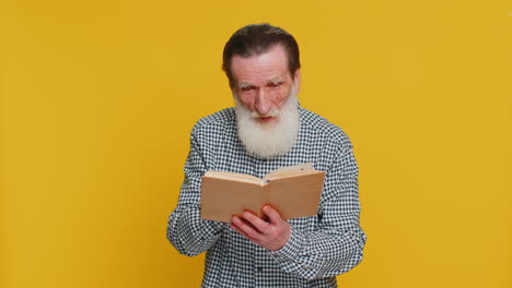 happy senior old man reading funny interesting fairytale story book leisure hobby learning study