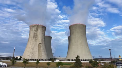 aerial approach toward nuclear power plant cooling towers while emit vapor