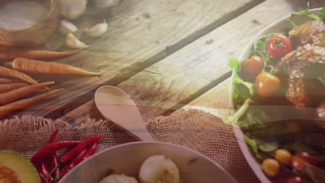 animation of landscape over plates with food on wooden background